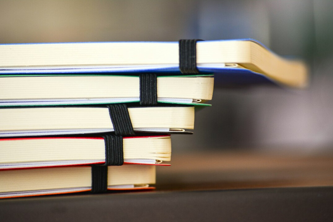 Stack of binder documents on a desk symbolizing compliance