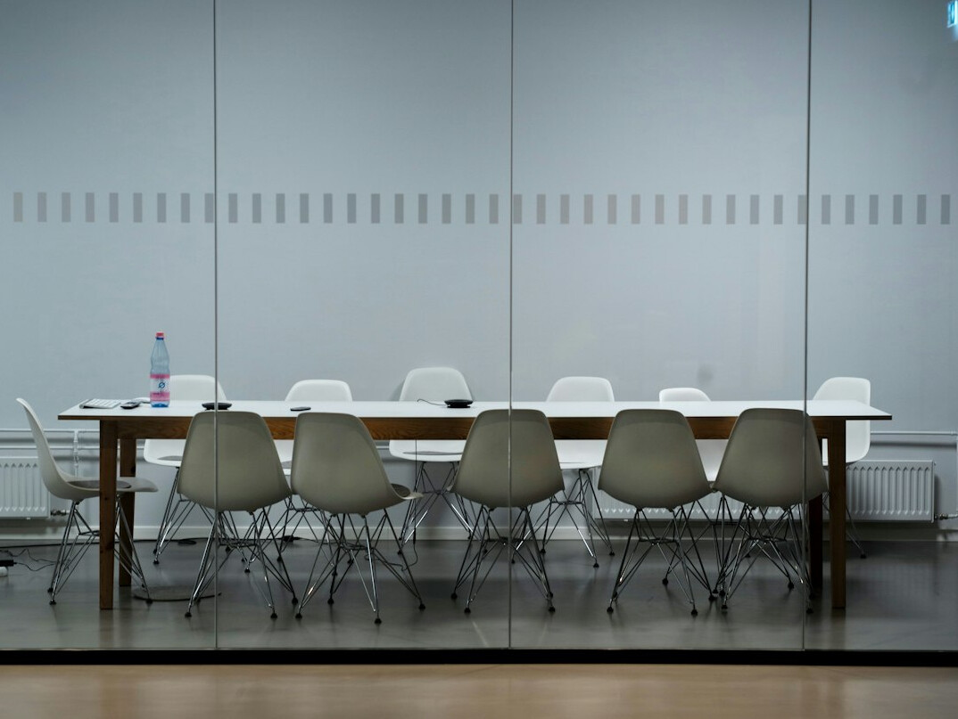 Modern meeting room table with laptops set up