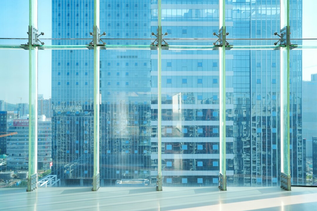 Modern office conference room with glass walls and city view