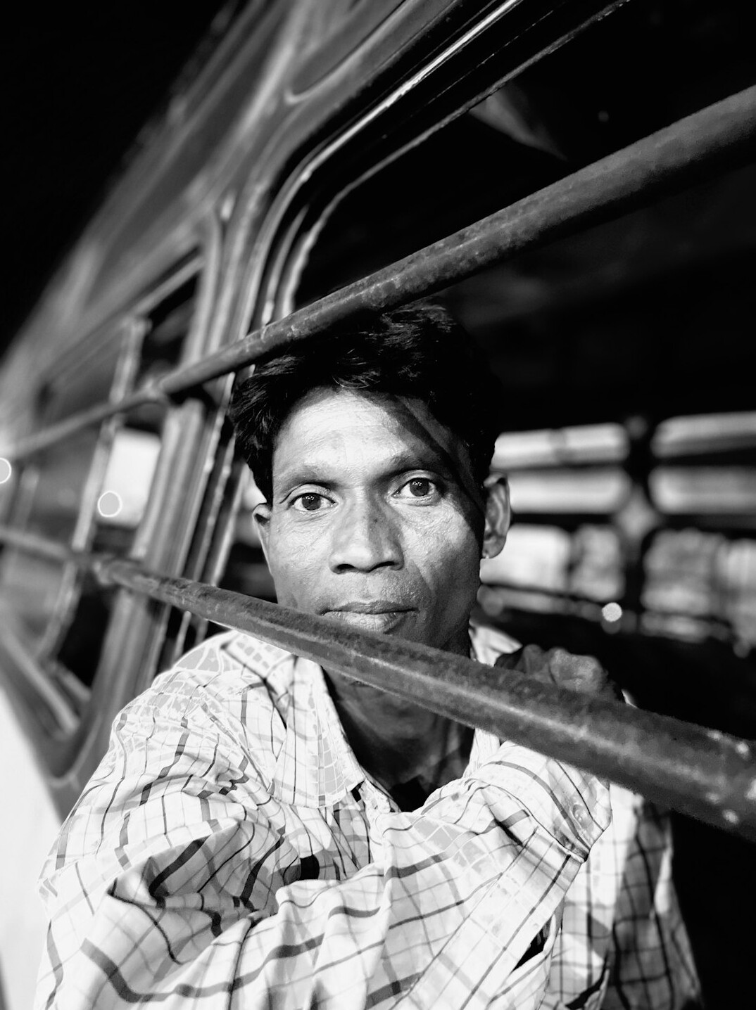 Studio portrait of an Indian Malaysian man in a collared shirt